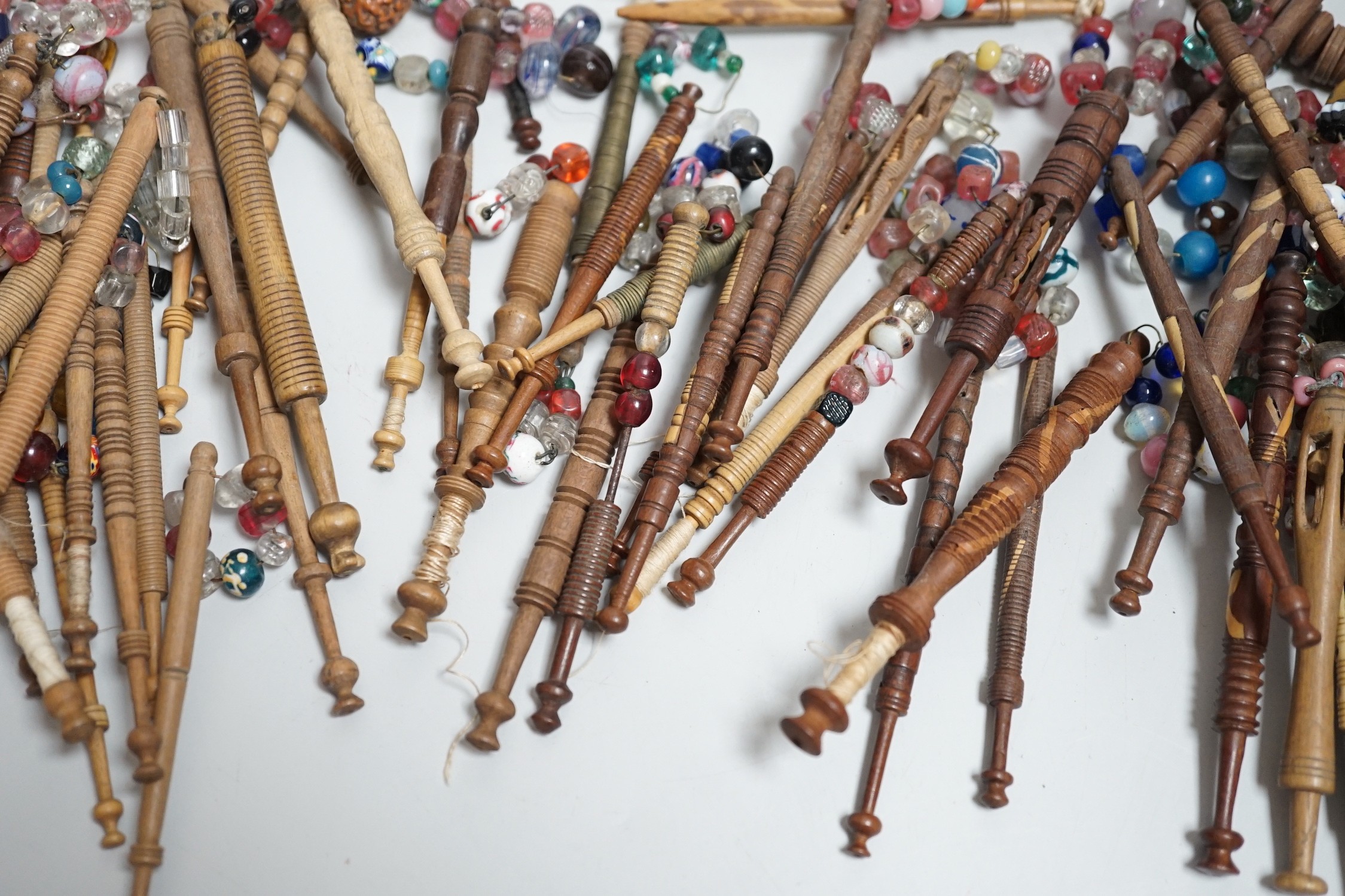 Fifty 19th century finely turned wooden lace bobbins with beaded ends together with 35 ornate wooden bobbins with beaded ends and 5 plain wooden bobbins unleaded (90)